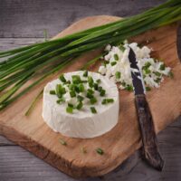 Allium Sativum chives in kitchen on chopping board grown from seed to harvest herbs for cooking
