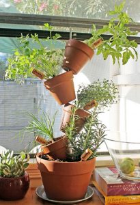 Crooked pot herb garden Arrange pots around a sturdy metal rod trough their drainage holes. The idea is to have it look like they are about to fall over. This is a quick and easy little vertical garden that promises plenty of herbs in a small space.