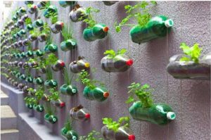 Recycled plastic bottle vertical herb garden One person's trash is another person's vertical garden, recycle your plastic bottles into an inexpensive creative vertical herb planter.